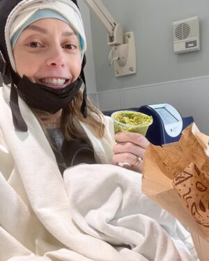 Grace Helbig Instagram - Scenes from chemo round 5! We’re officially 5/6th of the way through chemo!!! I can’t even process that right now, it’s all been so surreal. I brought this hat gifted to me by a friend of @mametown’s for a lil photo shoot. (If you listen to TMGW you know!) @elliottmorgan thought it was maybe “too dark” of a joke. Maybe he’s right, but I’ve lost my baseline for what’s normal or appropriate or “real life” at the moment so we’re just having fun! 5 infusions down! The adorable horrors of recovery await but we’re fucking doing it! 💪🏻🙃 #aintdeadyet