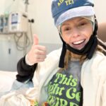 Grace Helbig Instagram – Scenes from chemo round 5! We’re officially 5/6th of the way through chemo!!! I can’t even process that right now, it’s all been so surreal. I brought this hat gifted to me by a friend of @mametown’s for a lil photo shoot. (If you listen to TMGW you know!) @elliottmorgan thought it was maybe “too dark” of a joke. Maybe he’s right, but I’ve lost my baseline for what’s normal or appropriate or “real life” at the moment so we’re just having fun! 5 infusions down! The adorable horrors of recovery await but we’re fucking doing it! 💪🏻🙃 #aintdeadyet