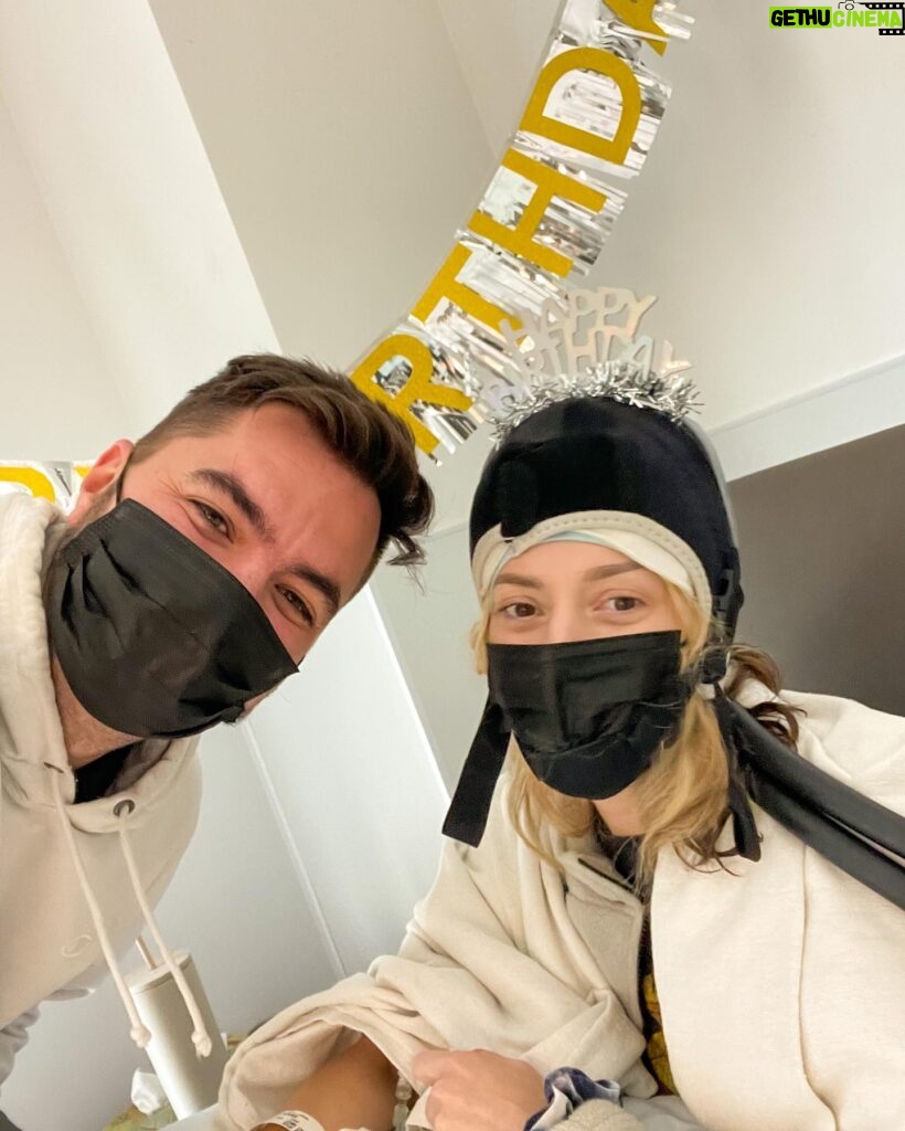 Grace Helbig Instagram - Today’s my birthday and we’re celebrating a little differently this year! It’s chemo round 3 bb!!! But @elliottmorgan set up these streamers and put this hat on me because he’s ADORABLE and it’s a good thing it looks so funny bc if it didn’t it would look very sad lol. It looks like how I feel: giving it my best shot. It’s been a real journey so far and it feels weird but appropriate to spend my birthday in a chemo chair. Thanks for all the well wishes and warm messages! We’re doing it!! And at least there’s still cocktails. 🙃