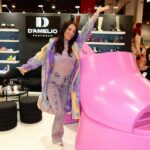 Heidi D'Amelio Instagram - You know it’s a good day when you see the giant pink Ravina shoe! 😍 Back at it in Vegas for @projectshow with @dameliofootwear! …y’all already know I still had to dress up for Mardi Gras while I’m here 💜💛💚