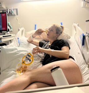 Iliza Shlesinger Instagram - Postpartum done right. I didn’t stop eating from the moment I had him until we left the hospital. ➡️ swipe to the end to see the @haveacornchips I accidentally dropped into his bassinet as I stood over him power eating and staring at my sweet little boy. It got wedged between the plastic and the mattress 🤷‍♀️ Hope he likes salty corn milk! 🧂 🌽 🥛 💦 the @yeti I just realized was there but YETI deserves a shoutout because the good ice they gave me at the hospital stayed AS ICE even after I got home. Best part is I’ve had it for years and it doesn’t give me lead poisoning. Bring it to your next delivery!