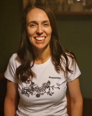 Jacinda Ardern Instagram - It’s NZ Music T-Shirt day, and to mark the occasion I popped on this shirt, donated to @musichelpsnz and got Clarke to take a photo of me with my eyes half closed.  I remember when Music Helps first launched - they do amazing stuff. In their own words “MusicHelps support hundreds of projects across Aotearoa, each using the power of music to change the lives of thousands in need. This includes music therapy, music programs in respite and palliative care, music education programs (particularly in low decile environments), music programs in prisons and rehabilitation and music in aged care to name but a few initiatives they support.

MusicHelps also provides emergency assistance to thousands of music people experiencing hardship and illness through their suite of music support services.” Huge thanks to music helps for the work you do, and to everyone supporting you today! #nzmusictshirtday #musichelps