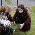 Jacinda Ardern Instagram - One of those mornings - managed to somehow slice my hand while unveiling a school plaque, then mid cutting a cake somehow spread icing liberally on my arm, pants and mask. But none of that mattered - this was the most beautiful school opening. Thank you Te Rōhutu Whio School for being so welcoming, and so fun! Hoping this accident prone morning doesn’t continue…I’m off to a meat works 😳