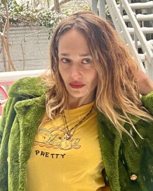 Jemima Kirke Instagram - I fucked Oscar the Grouch and all I got was this lousy coat. He said I was pretty. In a trashy kinda way. 

PS I’ve decided to continue smoking as an act of radical acceptance that looks are ephemeral. I’ll be hanging out at the finish line, cigarette in hand, ready to compare laugh lines. Mine will be deeper than yours. 

(Shirt by me. DM for price. 🫖☕️)