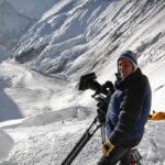 Jimmy Chin Instagram – Deeply saddened to hear about the passing of David Breashears this week. He was a friend and mentor and had an outsized influence on many peoples’ lives, including mine. I looked up to him long before I met him. His endeavors as an incredibly bold climber and world class mountaineer were legendary. He was also a human rights advocate, spokesperson for climate issues and someone I considered to be the greatest mountain filmmaker of our time. Among many notable films, David’s Everest IMAX film would become the highest grossing IMAX film of all time. It was a cultural phenomena for an entire generation.

In 2004, David invited me to climb Everest and film with him, @edviesturs, Veikka Gustaffson and Robert Schauer. I was a long shot candidate to fill the role he was proposing. I was young and had just started filming the year before. It was a pivotal moment in my career. David was intimidating and opinionated but deeply caring and had a razor sharp wit. He was brilliant and, some would say, complex. His exacting standards and high expectations pushed me to rise to a new and much higher level both as a mountaineer and as a cinematographer. We eventually climbed Everest together that year and became close friends. I learned a lot on that expedition. He taught me how to approach a major production on a big expedition and the attitude and ethos required to pull off a challenging project in good style. These were lessons I’ve carried with me throughout my career. I am forever grateful that he believed in me and for my time with him.

Here are a few images from the 2004 expedition including one of my favorite post Everest summit bad hair day images.

Rest In Peace my friend. You will be dearly missed.