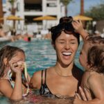 Kayla Ewell Instagram - The end of Summer & the beginning of my Birthday. ☀️ Sometimes you pack up the fam & take a last minute trip to Palm Springs right before school & a giant storm start. Family time is my favorite time. The kids loved every minute, including the car ride home. (We timed it perfectly & they slept the whole way home, little do they know that was the best present they could give.) •Dress & shoes are @zara •Jones’ trunks & oufit @zarakids •Onesie is our favorite @kytebaby •Bikini is @allsaints from a few years back & it’s still one of my favorites