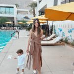 Kayla Ewell Instagram - The end of Summer & the beginning of my Birthday. ☀️ Sometimes you pack up the fam & take a last minute trip to Palm Springs right before school & a giant storm start. Family time is my favorite time. The kids loved every minute, including the car ride home. (We timed it perfectly & they slept the whole way home, little do they know that was the best present they could give.) •Dress & shoes are @zara •Jones’ trunks & oufit @zarakids •Onesie is our favorite @kytebaby •Bikini is @allsaints from a few years back & it’s still one of my favorites