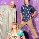 Kirsten Vangsness Instagram - #nationalcomingoutday here’s me being my queer bisexual self while being flanked by @detrinis & @muchosgarcias @lalgbtcenter where I get to romp about in #lottieplachetttookahatchet aka Queer Heaven created by @justinelizabethsayre this day is important to me because so much heartbreak happens on this planet & open visible queerness is one of one million ways way to heal the heartbreak. Here’s me, waving at you, fellow person on the LGBTQIA spectrum (& our friends) in the hopes it can ease someone else’s internalized homophobia or remind them they are valid and deserve safety and atunement. Coming Out Day is a thing that happens multiple times a month, a day. Each time I come out it’s a different cocktail - at its best it’s a mix of vulnerability, pride, bravery & joy but sometimes there’s shame in there, sometimes there’s fear, sometimes there’s a LOT of evil internal chatter. So it’s good to have a day to acknowledge this thing called coming out that many of us do because coming out is brave and wonderful and cleansing. Anything can transform with some air, time, sunshine, deep breaths and radical responsibility. Anything can transform into a more expanded thing, as we continue to come out and out and out we are part of creating a kinder more gorgeous world. Keep coming out. Even if it’s just to you. It counts. 🩷💙💜🌈🏳️‍🌈💥