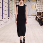 Maria Grazia Chiuri Instagram - With their ability to tame and transform textiles, shape silhouettes and control volumes, pleating and other forms of fabric manipulation play an important role throughout the new #DiorCouture Spring-Summer 2024 collection by @MariaGraziaChiuri. A white crêpe column exemplifies this type of #DiorSavoirFaire with its rows of precise pleats smocked to secure the positioning of the neckline and waist, while another draped dress is ingeniously gathered into a basketweave panel at the front. In red moiré faille, a pleated full skirt is paired with an update on the #DiorBarJacket to reinvent the original and peerless New Look icon.