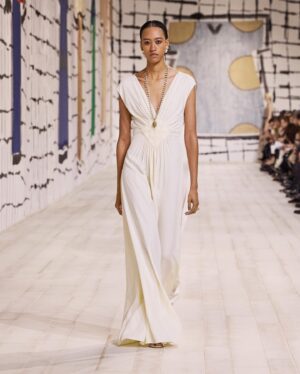 Maria Grazia Chiuri Instagram - With their ability to tame and transform textiles, shape silhouettes and control volumes, pleating and other forms of fabric manipulation play an important role throughout the new #DiorCouture Spring-Summer 2024 collection by @MariaGraziaChiuri. A white crêpe column exemplifies this type of #DiorSavoirFaire with its rows of precise pleats smocked to secure the positioning of the neckline and waist, while another draped dress is ingeniously gathered into a basketweave panel at the front. In red moiré faille, a pleated full skirt is paired with an update on the #DiorBarJacket to reinvent the original and peerless New Look icon.