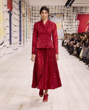 Maria Grazia Chiuri Instagram - With their ability to tame and transform textiles, shape silhouettes and control volumes, pleating and other forms of fabric manipulation play an important role throughout the new #DiorCouture Spring-Summer 2024 collection by @MariaGraziaChiuri. A white crêpe column exemplifies this type of #DiorSavoirFaire with its rows of precise pleats smocked to secure the positioning of the neckline and waist, while another draped dress is ingeniously gathered into a basketweave panel at the front. In red moiré faille, a pleated full skirt is paired with an update on the #DiorBarJacket to reinvent the original and peerless New Look icon.