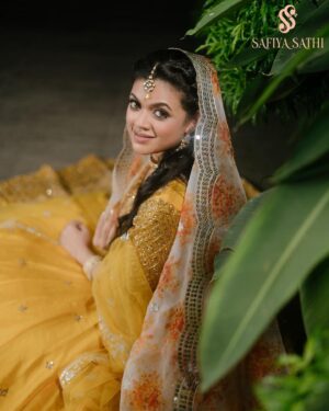Masuma Rahman Nabila Instagram - @masumanabila In @safiya_sathi 

Whether it is an intimate wedding or a grand one, some brides truly know how to stand out and make a statement with their bold outfit choices. So today, we are embracing all those women who chose or want to choose the beautiful color yellow for their wedding day and simply looked like a million bucks. A new edition to House of Safiya Sathi's wedding couture, a traditional zardousi lehenga, with an exquisite classic cut that looks stunning in the color yellow. There is absolutely no doubt that pastels have been and will always be in fashion. No matter what event you have, or what time the event is, pastel yellow will look stunning if you pick the right shade. This time we opted for a beautiful pastel yellow in motka silk which brings a serene, subtle, and elegant touch to it.

In frame: Masuma Rahman Nabila
Photography: @salmikabir 
Makeup: Nidia Afroz
Jewellery: Dazzle by Sonia

#holudattire