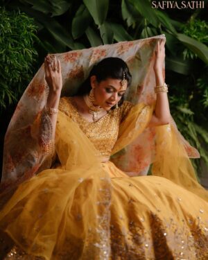 Masuma Rahman Nabila Instagram - @masumanabila In @safiya_sathi 

Whether it is an intimate wedding or a grand one, some brides truly know how to stand out and make a statement with their bold outfit choices. So today, we are embracing all those women who chose or want to choose the beautiful color yellow for their wedding day and simply looked like a million bucks. A new edition to House of Safiya Sathi's wedding couture, a traditional zardousi lehenga, with an exquisite classic cut that looks stunning in the color yellow. There is absolutely no doubt that pastels have been and will always be in fashion. No matter what event you have, or what time the event is, pastel yellow will look stunning if you pick the right shade. This time we opted for a beautiful pastel yellow in motka silk which brings a serene, subtle, and elegant touch to it.

In frame: Masuma Rahman Nabila
Photography: @salmikabir 
Makeup: Nidia Afroz
Jewellery: Dazzle by Sonia

#holudattire