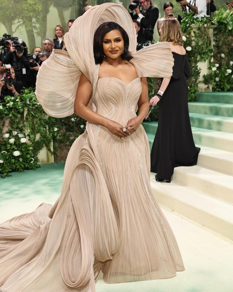 Mindy Kaling Instagram - The name of my gown was “The Melting Flower of Time”. I was so honored to wear the genius @gauravguptaofficial to the Met Gala this year. The cape was inspired by a blooming flower, and his signature sculptural techniques evoked the passage of time. Thank you Gaurav, @voguemagazine and the team of artists who designed my look! 🤍🤍🤍 📸: @gettyentertainment