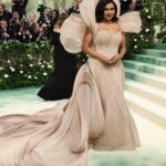 Mindy Kaling Instagram - The name of my gown was “The Melting Flower of Time”. I was so honored to wear the genius @gauravguptaofficial to the Met Gala this year. The cape was inspired by a blooming flower, and his signature sculptural techniques evoked the passage of time. Thank you Gaurav, @voguemagazine and the team of artists who designed my look! 🤍🤍🤍 📸: @gettyentertainment