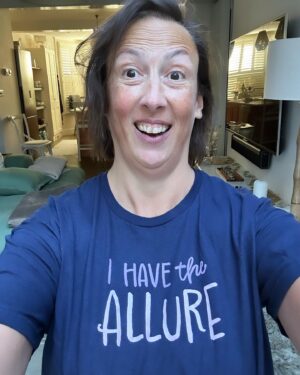 Miranda Hart Instagram - Sometimes, when my life and job involves posing in a t-shirt that states my ‘allure’ because it’s part of a comedy creation thingy I do, that can jar when you hold acute awareness of suffering in the same world. 
But I decided that the worst thing we can do is stop doing the things we do. Because not everyone can be on the frontline and we all have skills that the world needs and I suppose sometimes we just have to think about making our little patch of the world a fraction better for whatever silly or seemingly meaningless way. 
So here is me, my allure and my t-shirt from @themirandashop where I create some fun and cosy things that may help one or ten of you feel better. And remember you too have the allure!!! 🧡🧡