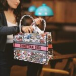 Natalie Portman Instagram - As we close the latest chapter of the #DiorBookTote Club, enjoy a last literary wander with Dior Ambassador @NataliePortman. In her #DiorSS24 bag imagined by @MariaGraziaChiuri, find the inspiring 'Hope in the Dark: Untold Histories, Wild Possibilities', by Rebecca Solnit, and the captivating 'On Photography', by Susan Sontag. © @MarionBerrin