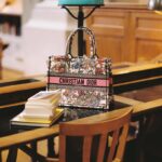 Natalie Portman Instagram - In the latest edition of the #DiorBookTote Club, Dior Ambassador @NataliePortman takes us on a literary journey through @INHA_Fr, with her bag from #DiorSS24 by @MariaGraziaChiuri. Stay tuned for the upcoming video, to discover the actress's treasured must-reads. The series is an ode to the power of books reflecting Dior's passion for creation and beauty in all its forms. © @MarionBerrin