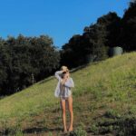 Olivia Rouyre Instagram – wish i was standing in a field in 100° topanga heat after swimming with friends ….. summer will make its return 🩲🦁🐦‍🔥