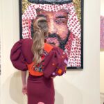 Pamela El Kik Instagram – من لحظة ما وصلت على مطار #الرياض #السعودية لأيّ مكان تواجدت في، انغمرت بِحُبّ شعبو والبسمة الحقيقية وحسن الضيّافة اللي ما إلا وصف👑
ممنونة ومشكورة لكل نقط الحُب 🇸🇦
#أنا_عربية 
•••

I decided to support a young talent from my country by wearing a full look from Nour Takieddine’s D2D collection.

•A collection inspired by the Dada art movement, created as a reaction to the violence and absurdity of world war 1.
In such hard times, I believe in the power of art as a great way to express our emotions, and rebel against the way our world functions today.

•Nour Takieddine’s collection was a perfect fit for my way of thinking, and I really wanted to wear this look tonight that consists of an extravagant jacket, with a fully hand embroidered back illustration of Emmy Hennings. 
I saw a part of me in this woman, and that was an extra reason for me to pick this specific look. 

•Hennings was a bold artist, poet, and performer who fought so much for her thoughts and questioned a lot the societal norms. All the handwork on the back of this jacket started from a one line drawing technique done by Nour, representing an autoportrait of Emmy. 

•The look also consists of an asymmetric skirt that has a deconstructed waistline, and a curvy hem another way to rebel against what we think is ‘normal’, the outfit is embellished with plexy laser cut elements representing words and geometric shapes referencing Dadaist paintings and exploring new materials that are considered odd or weird  applied on fabric.

• to complete the look with these special heels with hand embroidered abstract faces inspired by DaDa collages and plexy embellishments ✨
@n.tbynour 🧡