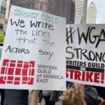 Sara Ramirez Instagram – Showing up in solidarity with @wgaeast for the Writers Guild strike and picket line in NYC. Better contracts NOW! The content we consume (and some of us perform 🙋🏽) would be NOTHING without writers. Thank you to all who are showing up to picket, pass out water, coverage, and all who are leading this action. I am here in solidarity as a member of WGA sibling union SAG/AFTRA. Power to the people! Also can I just say how many hilarious and creative picket signs there are? BECAUSE WRITERS WROTE THEM. 
.
Pic in color of 2 signs in the picket line (I’m holding the one that’s about writing the lines actors say:)) that read: “Spoiler Alert: We write the lines that the actors say. WRITERS GUILD OF AMERICA EAST”, and “#WGA STRONG, WRITERS GUILD ON STRIKE!”