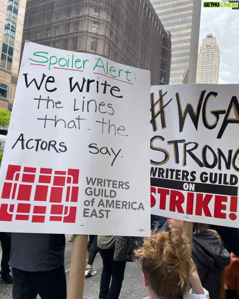 Sara Ramirez Instagram - Showing up in solidarity with @wgaeast for the Writers Guild strike and picket line in NYC. Better contracts NOW! The content we consume (and some of us perform 🙋🏽) would be NOTHING without writers. Thank you to all who are showing up to picket, pass out water, coverage, and all who are leading this action. I am here in solidarity as a member of WGA sibling union SAG/AFTRA. Power to the people! Also can I just say how many hilarious and creative picket signs there are? BECAUSE WRITERS WROTE THEM. . Pic in color of 2 signs in the picket line (I’m holding the one that’s about writing the lines actors say:)) that read: “Spoiler Alert: We write the lines that the actors say. WRITERS GUILD OF AMERICA EAST”, and “#WGA STRONG, WRITERS GUILD ON STRIKE!”