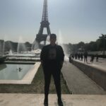 Sara Ramirez Instagram - That time I traveled with a good platonic friend 🎉 @thefreeactorvist 🎉who just got it (and still gets it) and there was mutual support and ease in co-creating a fucking GREAT time! Celebrating good platonic friendships because they matter too! 📷🎥: @thefreeactorvist . . . Image 1: Sara reclaiming Paris for themselves. They are facing the camera, sunglasses on, hands in pockets, standing in all black joggers, boots, jacket, black tshirt that reads “binaries are for computers” in black font over a square of white zeros and ones, ballcap that has “X=“ in white. Paris and the Eiffel Tower in the background, sunny clear sky. Image 2: Same everything except Sara’s head is turned to camera right. Video: Sara singing “You Oughta Know” by Alanis Morissette into a green lit mic at a red light district karaoke bar. Sara is wearing white joggers, a camo sweatshirt and same black ballcap with the “X=“ in white. Sara is FEELING IT. The bar is low lit in reds, purples, yellow and green, passersby in the background by the front door -some walking by and one just chilling watching from the cobblestone walkway outside.