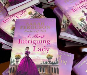 Sarah Ferguson Instagram - Looking for a holiday read? Our Sunday Times Top 5 bestselling novel, A Most Intriguing Lady is available at the link in my bio! Lady M is waiting to whisk you away into a world of mystery and intrigue. @harpercollinsuk @harpercollins @marguerite_kaye 

Photo: @debbieharephotography 
#holidayread #books #historicalromancenovels #holidayreading
