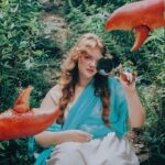 Shannon Purser Instagram - 🌷✨Backwoods Venus✨🌷 when I first saw these photos after our shoot in the summer, I didn’t know how to feel. they were beautiful. everything Valheria does is beautiful. she’s a true visionary and I consider myself so lucky every time we get to shoot together. the whole team behind these pictures is amazing and even though it was a humid, sweaty shoot in a creek that probably had snakes, it was a great day. so what was the hesitation? I felt exposed. I felt overwhelmingly aware of my body and how short it falls of the beauty standards our society has indoctrinated us with. indoctrinated me with. ever since I was maybe 10, I’d internalized the idea that fat is one of the worst things you can be. I learned that if you are fat, your options are to punish your psyche and your body until you are not or try to compensate however you can. I got good at makeup. I am strategic about how much skin I show and where. I cast myself as the “mom friend” even when it felt wrong because, in my mind, being desirable wasn’t really an option. I’ve realized over the years that I’m not just strategic about revealing my body. I’m strategic about revealing my soul- who gets to know me and how well. sometimes that’s wisdom. other times, it’s just a debilitating fear of vulnerability-a reflexive shrinking away from a potential hurt. what I do know is that the hiding hurts more than the exposure. dreading the moments someone wants to see me in my entirety, body and soul, hurts. so, here I am, exposing myself. I am not confident. I am just refusing to let my fear keep me from living. I am just me. photos: the legend herself, @valheria123 (she also did my nails bc what can’t she do?) makeup: @chandlerwest custom clothing and styling: @studio.tessafay hair styling and extensions: @_treyanthony @jessicawrighthair @your.mane.thing @melrosemcqueen assistants: the iconic @demetriusw @savanaogburn