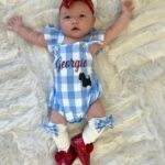 Tara Lipinski Instagram - Georgie’s 1st Halloween! ⛸️❄️ @bradgriffies made a costume that will be hard to match. Thank you!!!! Does anyone recognize it?! @toddkap commentated Gigi’s performance and I of course gave her an old school perfect 6.0 score of course! Brad - again thank you! It’s just too much. You are a talent and skaters are lucky to wear your beautiful designs. #babysfirsthalloween #halloween #newbornhalloween #figureskating #skating #olympics