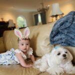 Tara Lipinski Instagram - Georgie’s first Easter and too many pics to count. Some of the ones that didn’t make stories. 🐰🥕 Our little family. 🫶 Hoping Sully thought the Easter basket was for him. Little man is so good with her, he just wants *needs* to part of everything. #easter #babysfirsteaster #babygirl #baby #6monthsold #parenting #babyanddog