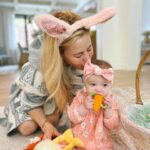 Tara Lipinski Instagram - Georgie’s first Easter and too many pics to count. Some of the ones that didn’t make stories. 🐰🥕 Our little family. 🫶 Hoping Sully thought the Easter basket was for him. Little man is so good with her, he just wants *needs* to part of everything. #easter #babysfirsteaster #babygirl #baby #6monthsold #parenting #babyanddog