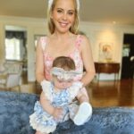 Tara Lipinski Instagram - Georgie’s first Easter and too many pics to count. Some of the ones that didn’t make stories. 🐰🥕 Our little family. 🫶 Hoping Sully thought the Easter basket was for him. Little man is so good with her, he just wants *needs* to part of everything. #easter #babysfirsteaster #babygirl #baby #6monthsold #parenting #babyanddog