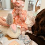 Tara Lipinski Instagram - Georgie’s first Easter and too many pics to count. Some of the ones that didn’t make stories. 🐰🥕 Our little family. 🫶 Hoping Sully thought the Easter basket was for him. Little man is so good with her, he just wants *needs* to part of everything. #easter #babysfirsteaster #babygirl #baby #6monthsold #parenting #babyanddog