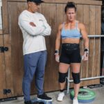 Tia-Clair Toomey Instagram - Sunday, 1:34pm: The fact that there is now a whole competition floor on the Dell Diamond concourse where a concession stand used to be — complete with 5 sets of double-under and lifting platforms, barricades and a sharp-looking @roguefitness backdrop — feels so natural, it’s easy to assume this was always the plan. It was not, but after four days of Book of Job-like weather, @caityhenniger and @billhenniger are taking no chances for the final event. Moving “The Cleanup” from the field to the concourse at the last minute is the latest example of the kind of logistical sorcery the @RogueInvitational has been performing behind the scenes all weekend. But not even Rogue can change the temperature, which dropped from 75° to 50° in the span of an hour earlier this morning. The top heat of women, the last of four heats, spend most of their 45 minute wait trying to stay warm; when @alexgazan_ 🇺🇸 takes a chair into the women’s bathroom, @laurahorvaht 🇭🇺 and @gabimiga 🇵🇱 follow suit. @tiaclair1 🇦🇺 remains outside, pacing around the warmup area with @shaneorr01’s jacket draped across her shoulders like a cape, superhero style. Shane, down to a just a longsleeve t-shirt, paces with her, shivering so hard he’s practically vibrating. A member of the Rogue event team notices, removes his own brand new Invitational hoodie and offers it to Shane, who accepts it with a mix of surprise and gratitude. By the time he pulls it on, @nick.p.jeffries is back at work, the only person on the concourse wearing shorts and a t-shirt. If you want to know what people mean when they say the Rogue Invitational goes above and beyond — it’s this. ✍🏽: @christinedca 📷: @emomphoto