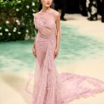 Victoria Beckham Instagram - British star, Phoebe Dynevor wore a custom Victoria Beckham gown to last night’s Met Gala. In a nod to this year’s ‘Sleeping Beauties’ theme, the ethereal silhouette was hand-crafted from archival lace, and embellished with over 300 lace appliqué flowers, hand-cut and hand-sewn onto a tulle base. Find out more in stories… #VBMetGala