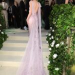 Victoria Beckham Instagram - British star, Phoebe Dynevor wore a custom Victoria Beckham gown to last night’s Met Gala. In a nod to this year’s ‘Sleeping Beauties’ theme, the ethereal silhouette was hand-crafted from archival lace, and embellished with over 300 lace appliqué flowers, hand-cut and hand-sewn onto a tulle base. Find out more in stories… #VBMetGala