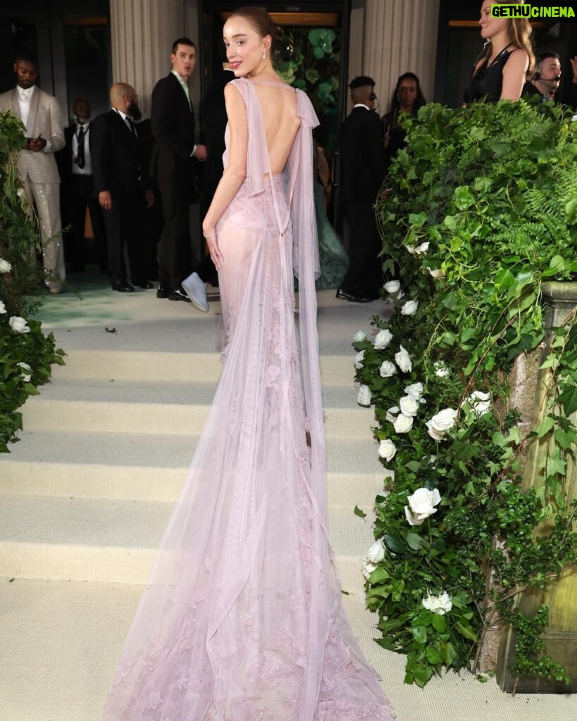 Victoria Beckham Instagram - British star, Phoebe Dynevor wore a custom Victoria Beckham gown to last night’s Met Gala. In a nod to this year’s ‘Sleeping Beauties’ theme, the ethereal silhouette was hand-crafted from archival lace, and embellished with over 300 lace appliqué flowers, hand-cut and hand-sewn onto a tulle base. Find out more in stories… #VBMetGala