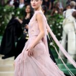 Victoria Beckham Instagram - British star, Phoebe Dynevor wore a custom Victoria Beckham gown to last night’s Met Gala. In a nod to this year’s ‘Sleeping Beauties’ theme, the ethereal silhouette was hand-crafted from archival lace, and embellished with over 300 lace appliqué flowers, hand-cut and hand-sewn onto a tulle base. Find out more in stories… #VBMetGala