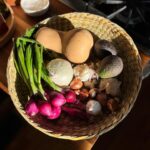 Alice Waters Instagram - This is my Kitchen Basket!It's the newest addition to a little kitchen collection I've collaborated on with my daughter @fannysinger's company @permanentcollection. The collection is a group of pieces modeled some of my favorite kitchen implements: my Egg Spoon, my mortar & pestle, my salad bowl, and now, my indispensable kitchen basket! This basket is permanently installed at the end of my butcher block, a place to keep onions and garlic and whatever else gathers there. I use it to harvest lettuces in my Victory Garden and take it out to transport all the food for an instant picnic. It makes everything look beautiful! Handwoven by Clair Murphy in England from rush gathered in the rivers of Somerset, it's a reminder of our connection to the beauty of nature.