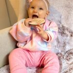 Alicia Banit Instagram - 7 months of our Isla Joy! This little possum has a top tooth, has tried more foods than I can count and babbles MAMA among other words! I’m not sure she knows what she’s saying but I’m claiming it, her first word is definitely mama! She watches our mouths so intently when we try to teach her new words and she’s back in her dinosaur era roaring at everything. She whispers to herself and breathes like darth Vader when she’s bored and I honestly have never met a more smiley, laughable bub. Even through her first cold, our girl didn’t have a single day where she didn’t laugh and smile her way through it. We couldn’t be more in love with her, she is pure perfection 🥹