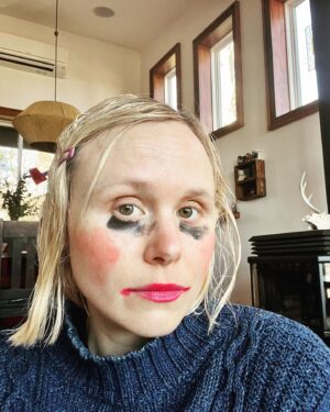 Alison Pill Instagram - Sometimes your stylist gives you a new look and…it just. Works.
(Image description: a blonde woman has black eye makeup spread under her eyes, lipstick over the lip line, extreme pink blush on her cheeks and a purple barette in damp hair)