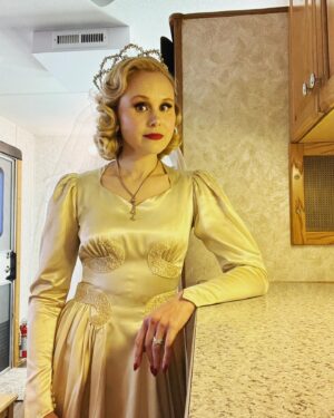 Alison Pill Instagram - Myrtle before life’s disappointments.  And a huge thank you to our incredible hair, makeup, wardrobe, props, set Dec, design team, camera crew, grips, ADs, flipping everyone who gave their all to make this show look sooooooo good. This look is for one shot of a wedding photo, just to give a sense of the attention to detail. (Image description: a white blonde woman in wedding veil and satin wedding dress in a trailer leaning against a counter) #hellotomorrow on @appletvplus