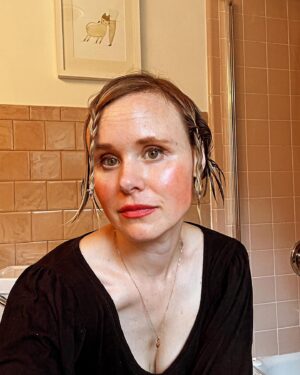 Alison Pill Instagram - Welp the @sagaftra strike is officially over and awards season is beginning.  So my stylist (recently turned seven) is hard at work coming up with new lewks.  You know who else is hard at work? The people of @unitehere11 who have been striking for months at many LA hotels seeking a fair deal.  Some of the awards shows? Set to be at these hotels. Let’s turn this #hotlaborsummer into a #coollaborwinter and support these people as they’ve supported us.  Sign the pledge (link in bio) to make sure the hotels and organizers know no union actor is going to cross a picket line. (Image description: a white woman with several tiny braids and a lot of blush and  messy lipstick sits with a background of bathroom tiles)