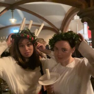 Amalia Holm Bjelke Instagram - Having been a choir child in Sweden I can’t let the 13th of December pass without joining in on some kind of Lucia celebrations. Last year in Vancouver, me and lingo-genius @arlenaguayostewart rehearsed the Lucia song lyric (for days) in the green room on set, brought @ashleynicolewilliams in on the tune and ever eager @sherrylrandall was on top of getting us something resembling Lucia-equipment. The intention was to surprise the crew in the dark factory building (which had excellent acoustics) as we were completing episode 2 of @motherlandtv season 3. But film set logistics are NOT to be screwed with and the risk of our innocent Lucia gimmick ruining anything on that tight schedule was simply not worth it on the day. For another time! This year I’m at home and getting the full experience, as part of a wonderful and tight choir. The duet in the video by me and Maria is a welcoming song as Lucia strides towards us, portrayed gracefully by my friend @nikiblomberg. Joyful moment af. As I’m catching up on Lucia celebrations lost and just hate to see great acoustics not be utilized, I also made a little Lucia-celebration for the neighbors in the 120 year old stairwell of our building on the morning of. (The elevator note says to open your apartment door if you want to hear the Lucia songs). The meaning of Lucia celebrations is to bring light and hope in (literal) dark times. 🕯️ Happy Lucia! 🕯️