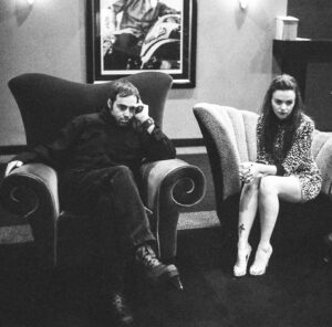 Amber Tamblyn Instagram - My least favorite person and 17th favorite poet is 50 years young today (yesterday, really) and I can’t believe how many poetry tours on motorcycles, arguments in bars, impromptu shows in living rooms, lifeguard towers, and double decker buses we’ve been through together— how many cigarettes we’ve wanted to put out on each other’s faces, how many bottles of bourbon we’ve raced to the bottom of, how many people’s broken hearts we’ve shattered or helped put back together again, how many horrible, honest, holy moments we’ve shared along the way. Twenty years to be exact. (See our first show flier from Upright Citizens Brigade in 2004.) We were such young puppies in some of these pictures taken by @mattwignall across too many tours and cities to count. Now look at us: too old to party and too hot to handle. 

Happy birthday, brother. I love you, occasionally. Someday I hope they write a movie about your crazy life and cast a less attractive, semi-talented Harry Styles. Until then, nothing can imitate the real thing: you, and what you’ve got, and what you’ve given to the world.

“Teased by success, 
we are like vampires in a tampon factory. It doesn’t have to be that way. 

Someone plug my lungs back into the guitar amps. All distortion, all the time. 

Aren’t you sick of being appraised wholesale? Aren’t you sick of sailing on listing ships? Aren’t you weary from playing cello with ex-lover’s bones?

I am.”

-All Distortion All The Time, Derrick Brown

#DerrickBrownPoetry
