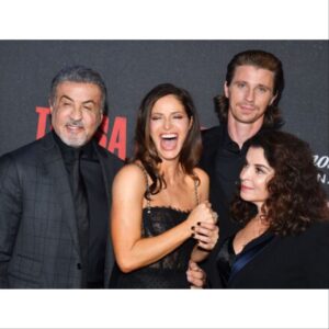 Andrea Savage Instagram - So thrilled to be in nyc for the @tulsaking premiere!! What a fantastic night!! I truly felt incredible. ❤️ The last two pics I added because they made me chuckle. One we all look like wax statues and the other @officialslystallone and I clearly are finding something hilarious that @garretthedlund is not amused by. 🤣🤣 No clue what it was! Holy crap, only two days away from the premiere 11/13 on @paramountplus And I have to just say a HUGE thank u to the village that made me feel like a million bucks, after taxes. A magical night!! #tulsaking Stylist: @taraswennen Makeup: @rebeccarestrepo Hair: @matthewmonzon Dress: @dolcegabbana Shoes: @stuartweitzman Jewelry: @simandroz