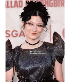 Anna Brisbin Instagram - The Hunger Games: The Ballad of Songbirds and Snakes…. sksksjsjjsjssnbsbd where to BEGINNNNN??!?!?! 

This premiere was everything. I adored the Hunger Games books and movies and never thought we’d be BACK IN PANEM but as horrendous and bloodthirsty as it is, IT FEELS SO GOOD TO BE BACK. 😂 And this movie is BEAUTIFUL. Watching Coriolanus Snow become who he’s destined to be is FASCINATING I LOVE A VILLAIN ORIGIN STORY. Tom Blyth killed it as Corio, and Dr. Gaul is probably my fav Viola Davis role ever, but I think *everyone* will be even more blown away by RACHEL FREAKIN ZEGLER and her STTTUUNNNINNGGG, INSPIRING, WONDERFUL, TALENTEDBRILLIANTINCREDIBLEAMAZINGSHOWSTOPPINGSPECTACULAR Lucy Gray Baird!! That girl can SING and BREAK YOUR HEART in two seconds flat! 💜🎙️🕊️✨ @tomblyth @violadavis @rachelzegler

This story is gripping from beginning to end. Which is impressive because baby she’s LONGGG. I feel like I just watched a whole trilogy in one sitting but I LOVED IT. 😍🕊️🐍✨

Thank you thank you thank you @lionsgate for the invite to the premiere. For dress code you said “Capitol Chic” and I asked myself What Would Cinna Do. 💛✨ Now brb I’m going to binge the original movies IMMEDIATELY.

@thehungergames #LionsgatePartner #TheHungerGames #TheBalladOfSongbirdsAndSnakes