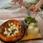 Annabel Crabb Instagram - Breaking: There is now a very satisfying nuclear escalation going on among my children re breakfast in bed. My 17yo, a naturally competitive tyke, learned of yesterday’s fish finger sandwich delivery by her puny sibling and has returned serve blisteringly with this Dutch Baby featuring smoked salmon, whipped cream cheese w capers, cornichon, thyme, lemon zest, green olives and served with a rocket salad and an apple and elderflower spritz on the side. All just ridiculously delicious… all eyes on the 14yo now. And on the 11yo who is away on a sleepover and will shortly return to find her palace of breakfast dominance memorably ransacked OMG. Swipe for further plating photography also the moment last night when - going to bed - I formally acknowledged that the book pile is getting a bit too tottery.