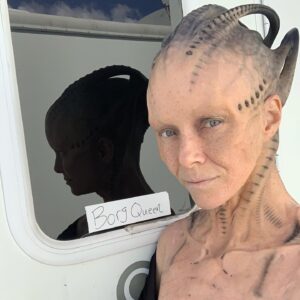 Annie Wersching Instagram - Sick of #Picard posts yet? 
😉👑👽Never, you say?! Great! 
In honor of our panel at @wondercon today, this one goes out to the incredible artists who designed, executed and applied this tricky prosthetic.  In the beginning I was called 4 hours before I was due on set. That included everything…hair in a bun, bald cap, crown on, 10 overlapping prosthetics, airbrushing and hand painting. Then costume and corset and all the rest. We very quickly got the whole shebang down to 2 1/2 hours! I’d go film some snarky BQ scenes and then it would take about 25 mins to remove the makeup pieces. I would let my hubs/family know I was almost finished by sending one of these ridiculous pics of prosthetics being cut off my face! 🤣 Some of my favorite times throughout my whole #StarTrekPicard experience were sitting in the chair being worked on by @jrmackinnon amd @kevinkirkpatrickart. I mean….what talent! And what great humans.❤️@vincentvandykefx and his team created piece after piece and @nevillepage was the concept artist for the whole thing! They did all of this while under the strictest of Covid protocols. I applaud them tremendously and I’m sure they’ll win lots of Emmys. 🏆 As they should! 
Don’t even get me started on @christineclarkdesign and @syzygy_designs and their ridiculously amazing detailed fittings and BQ costume…We’ll save that for next week ;) @startrek @startrekonpplus #picardbts